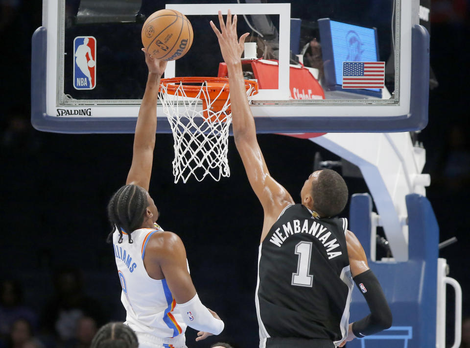 San Antonio Spurs center Victor Wembanyama (1) goes up to block the shot of Oklahoma City Thunder forward Jalen Williams (8) in the first half of a preseason NBA basketball game, Monday, Oct. 9, 2023, in Oklahoma City. (AP Photo/Sarah Phipps)