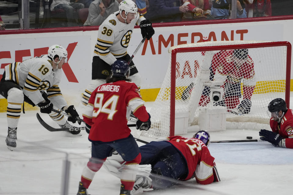 Boston Bruins center Johnny Beecher (19) scores a goal against Florida Panthers goaltender Sergei Bobrovsky (72) during the second period of an NHL hockey game, Wednesday, Nov. 22, 2023, in Sunrise, Fla. (AP Photo/Marta Lavandier)