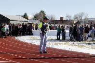 Sheriffs deputies stand guard over students after they were evacuated to the track and football field at Arapahoe High School in Centennial, Colo., on Friday, Dec. 13, 2013, where a student shot at least one other student at a Colorado high school Friday before he apparently killed himself, authorities said. The shooter entered Arapahoe High School in a Denver suburb armed with a shotgun and looking for a teacher he identified by name, said Arapahoe County Sheriff Grayson Robinson. (AP Photo/Ed Andrieski)