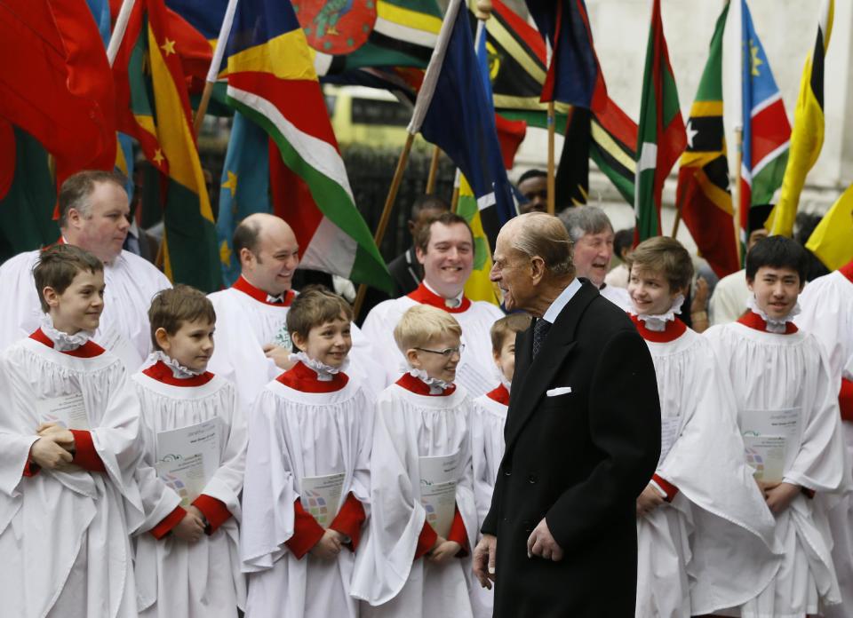 Britain's Prince Philip speaks to choir boys after attending the Commonwealth Day Observance service at Westminster Abbey in London, Monday, March 11, 2013. Britain's Queen Elizabeth II was due to attend but cancelled Monday as she continues to recover from her recent illness. Commonwealth Day Observance has a different theme every year, with the 2013 focus on ‘Opportunity through Enterprise.’ Queen Elizabeth II is the head of the Commonwealth, a voluntary association of 54 countries. (AP Photo/Kirsty Wigglesworth)