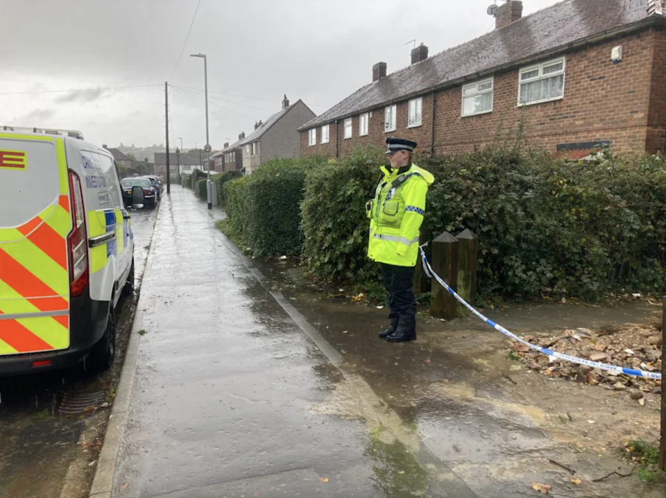 A police officer at the scene on Aysgarth Avenue in Lightcliffe, near Halifax, where a woman's body was discovered. Source: Reach