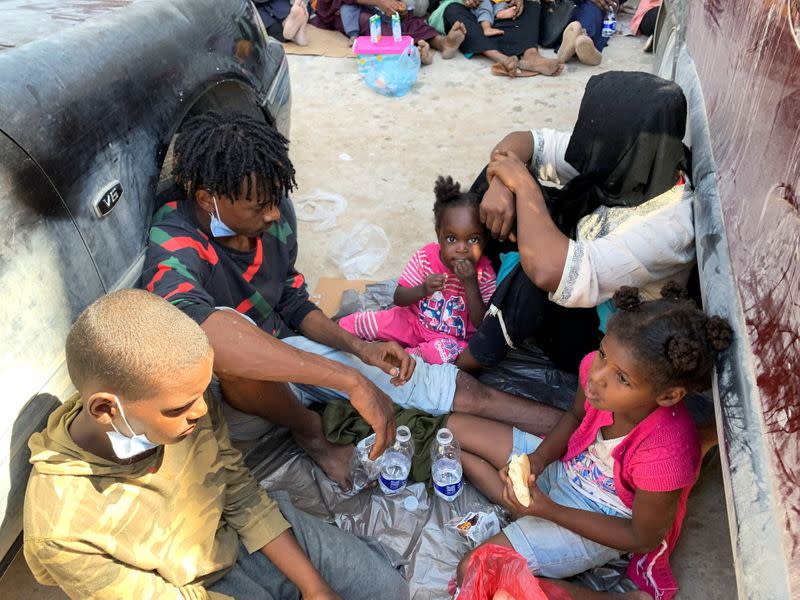 Migrants take rest as they waits outside the United Nations High Commissioner for Refugees (UNHCR) negotiation office in Tripoli