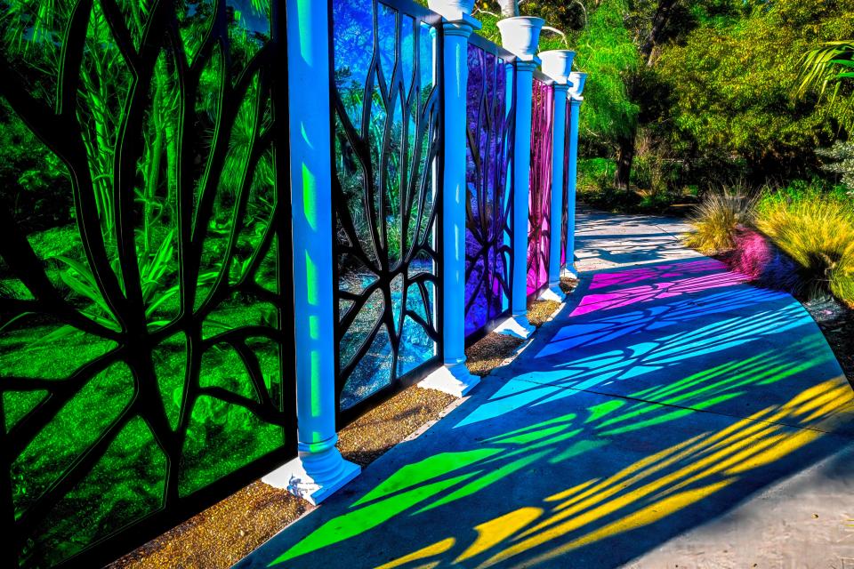 A spectrum of colored panels with the stylized silhouettes of the century plant line the succulent garden at Selby Gardens for the exhibition of “Tiffany: The Pursuit of Beauty in Nature.”