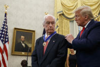 President Donald Trump presents the Presidential Medal of Freedom to auto racing great Roger Penske during a ceremony in the Oval Office of the White House, Thursday, Oct. 24, 2019, in Washington. (AP Photo/Alex Brandon)