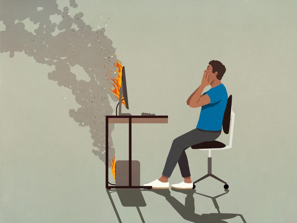 Shocked man sitting at smoking computer on fire - stock illustration