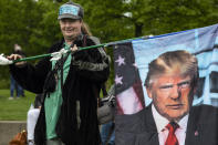 Paul Roblyer from Portland, Ore. holds a flag with an image of former President Donald Trump as a few hundred people attend a second amendment rally at Riverfront Park on Saturday May 1, 2021 in Salem, Ore. (AP Photo/Paula Bronstein)