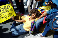 <p>An opposition supporter simulates a faint for hunger during a rally to demand a referendum to remove President Nicolas Maduro in Caracas, Venezuela, June 7, 2016. (Reuters/Ivan Alvarado) </p>