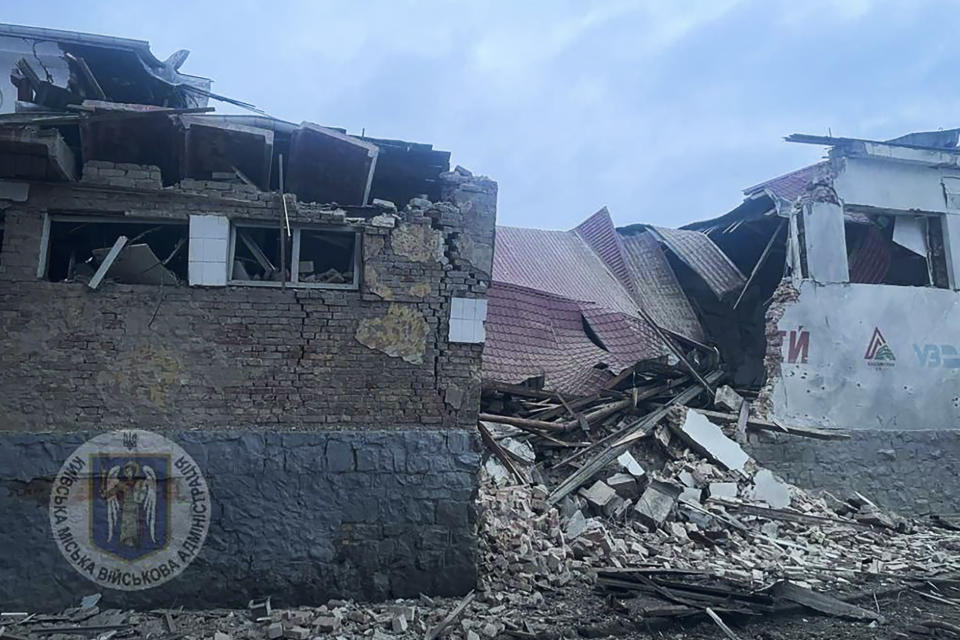 In this photo provided by the Kyiv Regional Military Administration, debris of a destroyed apartment building is seen after a Russian attack in Kyiv, Ukraine, Tuesday, Jan. 23, 2024. (Kyiv Regional Military Administration via AP)