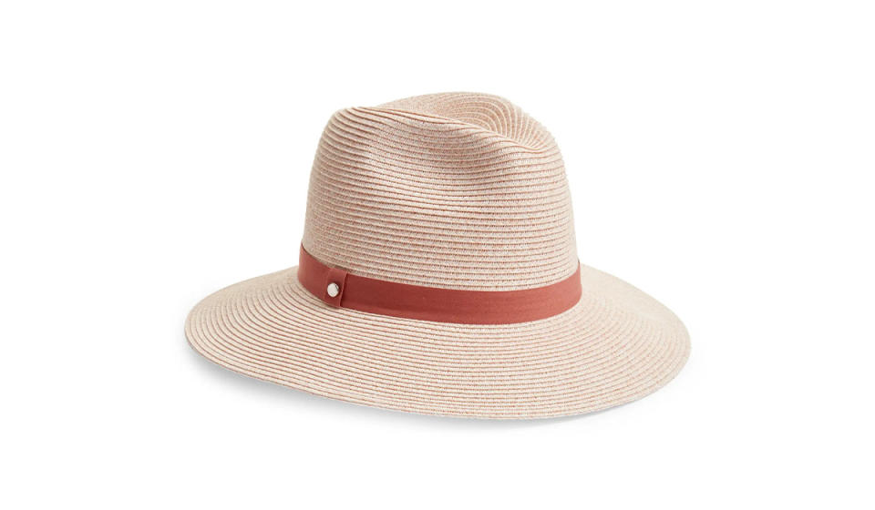 Pink-hued wide brimmed Panama hat with band. 