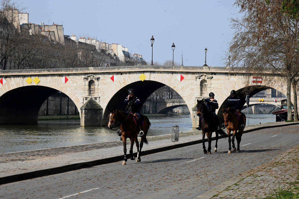 Image: Mounted policemen patroling along the banks of the Seine river, on the fourth day of a strict lockdown in France aimed at curbing the spread of COVID-19 caused by the novel coronavirus (Bertrand Guay / AFP - Getty Images)