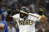 San Diego Padres' Tommy Pham (28) slams his bat into his helmet after striking out during the third inning of a baseball game against Los Angeles Dodgers Tuesday, June 22, 2021, in San Diego. (AP Photo/Denis Poroy)