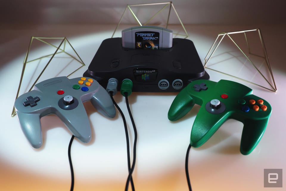 <p>Nintendo 64 on a white table with games</p>
