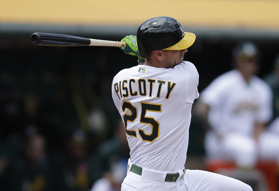Oakland Athletics' Stephen Piscotty swings for a two-run single off Los Angeles Angels' Cam Bedrosian in the fifth inning of a baseball game Monday, May 27, 2019, in Oakland, Calif. (AP Photo/Ben Margot)