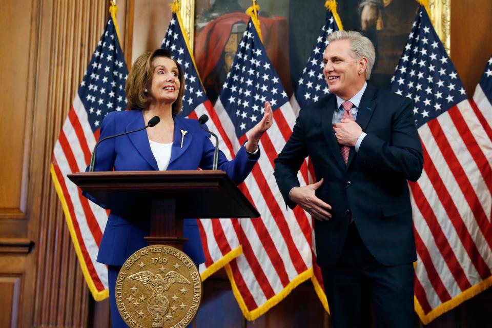 House Speaker Nancy Pelosi, D-Calif., and House Minority Leader Kevin McCarthy, R-Calif., participate in a bill enrollment ceremony for the Coronavirus Aid, Relief, and Economic Security (CARES) Act, after it passed in the House on Friday.