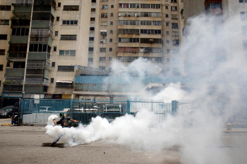 A demonstrator throws back a tear gas canister while clashing with security forces on July 20.