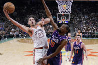 San Antonio Spurs forward Zach Collins (23) shoots around Phoenix Suns forward Kevin Durant (35) during the second half of an NBA basketball game in San Antonio, Monday, March 25, 2024. (AP Photo/Eric Gay)