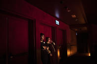 In this Oct. 11, 2019 photo, two workers stand inside a theater during a play in Hong Kong Disneyland in Hong Kong. The body-blow of months of political protests on Hong Kong’s tourism is verging on catastrophic for one of the world’s great destinations. Geared up to receive 65 million travelers a year, the city’s hotels, retailers, restaurants and other travel-oriented industries are suffering. But some intrepid visitors came specifically to see the protests and are reveling in deep discounts and unusually short lines at tourist hotspots.(AP Photo/Felipe Dana)