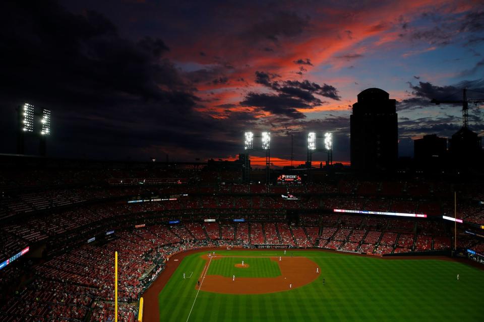 The sun sets over Busch Stadium during a game between the St. Louis Cardinals and the Cincinnati Reds on June 4, 2019.