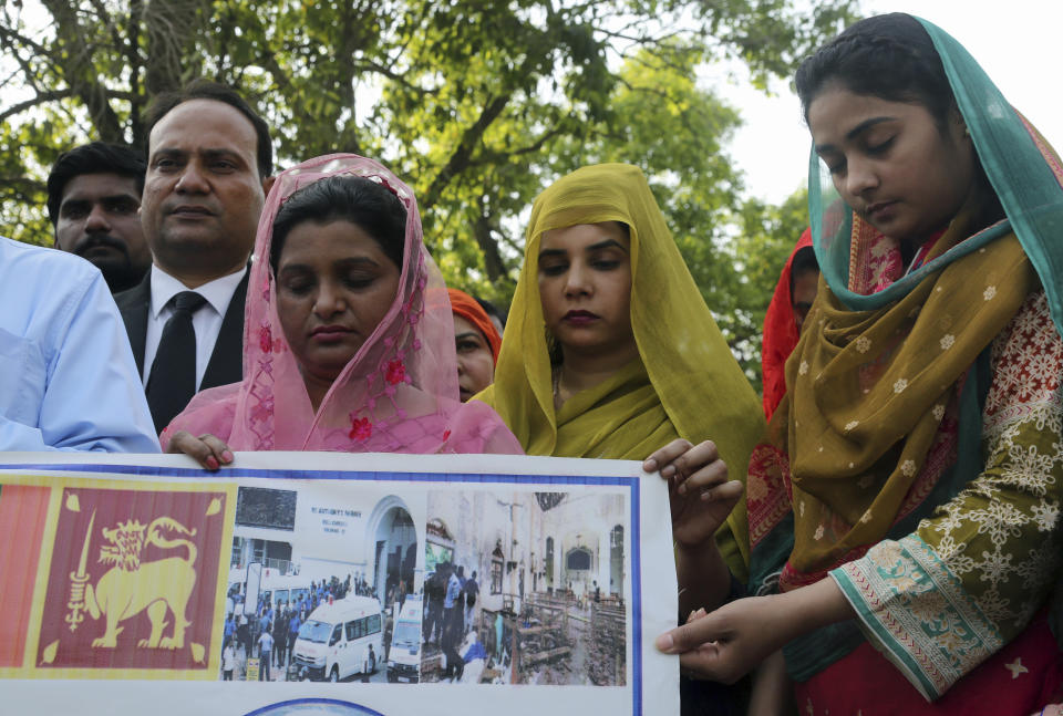 People attend special prayers for the victims of bomb explosions in churches and hotels in Sri Lanka, in Lahore, Pakistan, Monday April 22, 2019. (AP Photo/K.M. Chaudary)