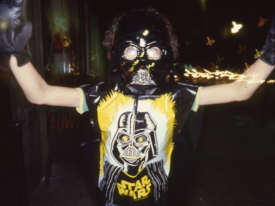 A child dressed in a Darth Vader costume in the 1970s.