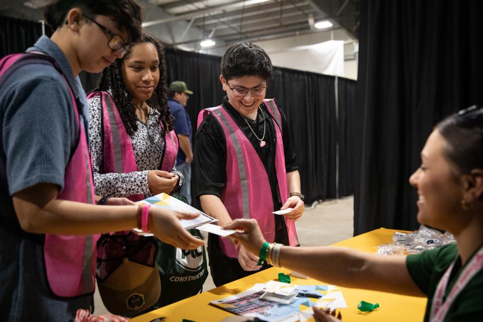 Del Mar welding students and Coastal Bend Women in Industry Conference volunteers, from left, Mia Aguinuga, Liv Garcia and Sam Marin, speak to PLC Construction's Alysha Decou during the conference on Thursday, April 11, 2024, in Robstown, Texas. The Canadian company builds refineries and furnaces, Decou said.