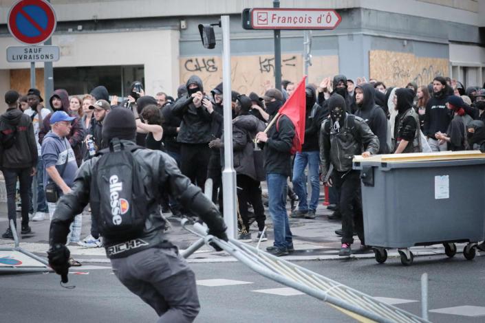 A protester moves a metal barrier during a demonstration in Caen, north-western France (AFP via Getty Images)