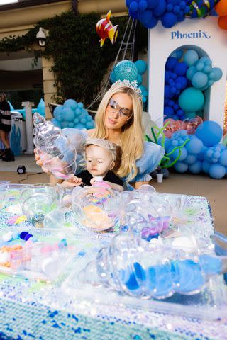 <p>Kevin Ostajewski</p> Paris Hilton makes sand art with son Phoenix at his first birthday party