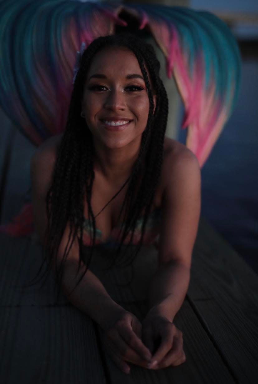 Imari Stout poses for a portrait in a Finfolks Productions mermaid tail. Stout is a professional mermaid performer with Wands and Wishes Mermaids. She performs under the stage name Mermaid Naia.