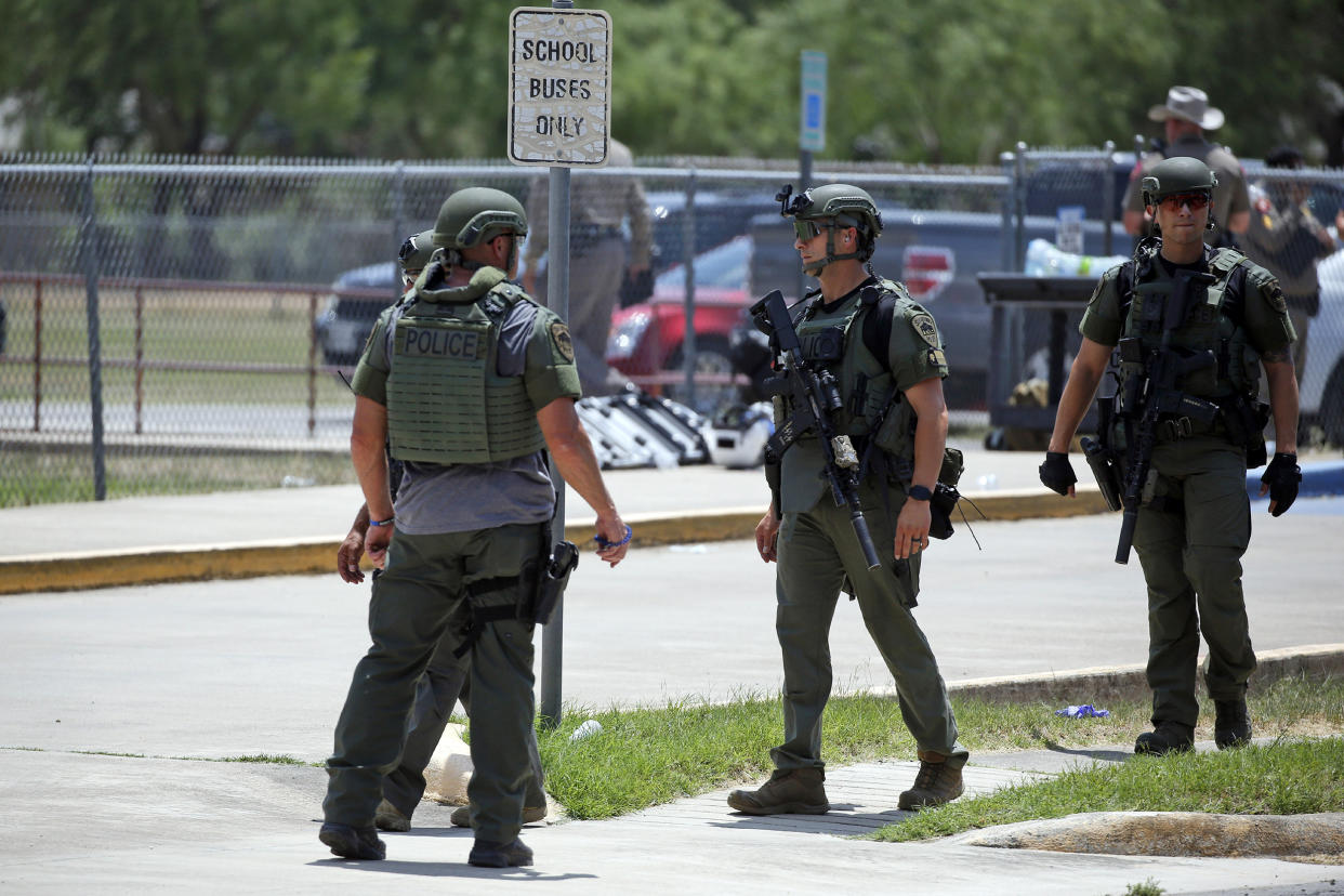 Image: Law enforcement personnel stand outside Robb Elementary School following a shooting on May 24, 2022, in Uvalde, Texas. (Dario Lopez-Mills / AP)