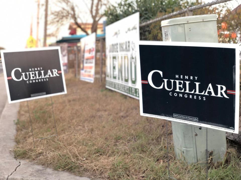 Yard signs for longtime Democratic Rep. Henry Cuellar dot a yard outside a polling station in central Laredo. Cuellar faced off against challenger Jessica Cisneros in a May runoff.