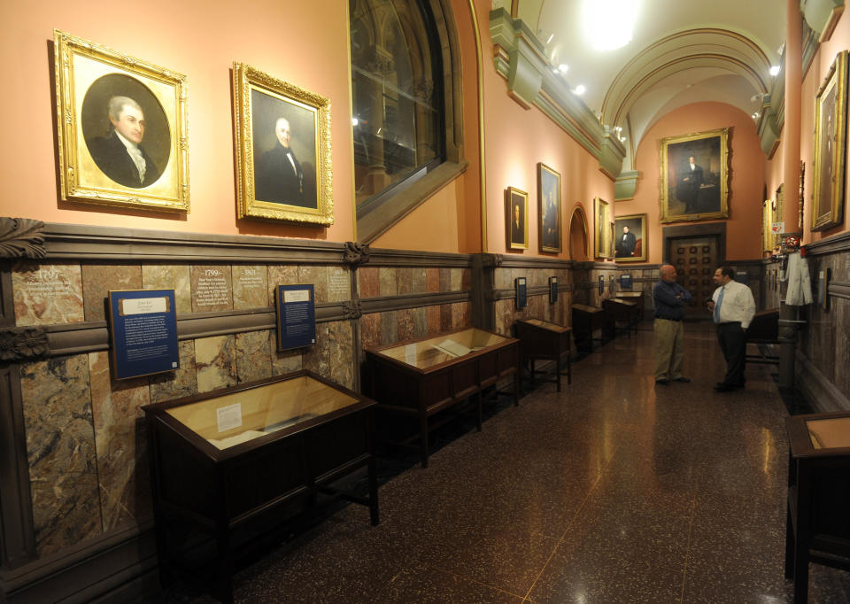In this July 31, 2012 photo, display cases filled with historic documents and painted portraits of former governors line the Hall of Governors on the second floor of the Capitol in Albany, N.Y. Historic artifacts that have been kept in storage for years are now on display in the corridors of the Capitol and the adjacent Empire State Plaza. (AP Photo/Tim Roske)