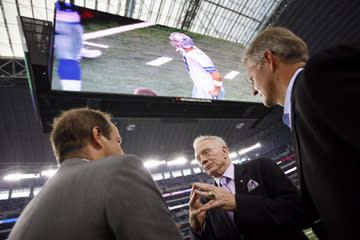 <b>Dallas Cowboys owner Jerry Jones and two other men talk underneath the new giant HDTV in Cowboys Stadium on Aug. 21, 2009.</b> Tom Pennington/<a class="link " href="http://www.gettyimages.com" rel="nofollow noopener" target="_blank" data-ylk="slk:Getty Images;elm:context_link;itc:0;sec:content-canvas">Getty Images</a>