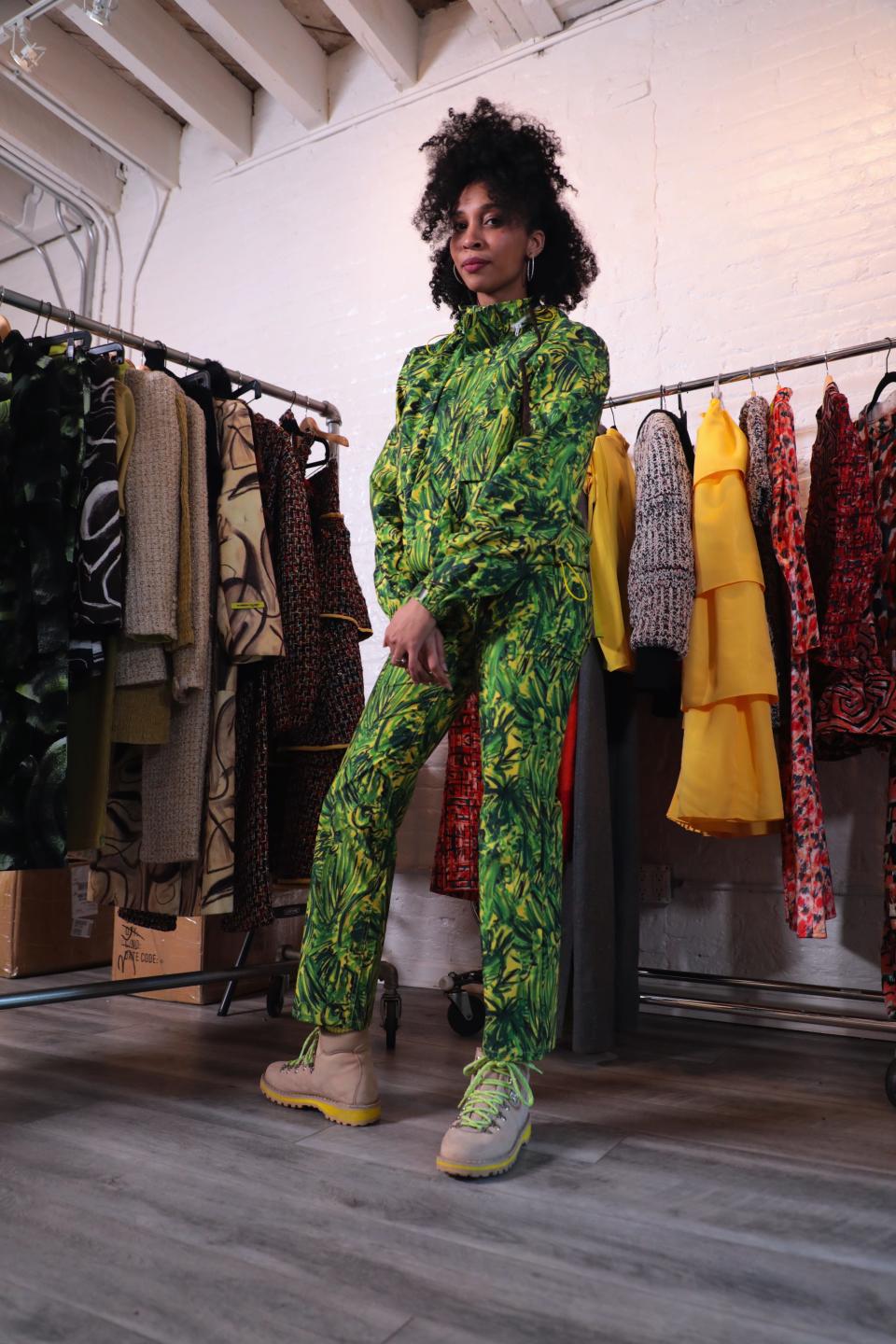 Marrisa Wilson stands surrounded by racks of her designed garments