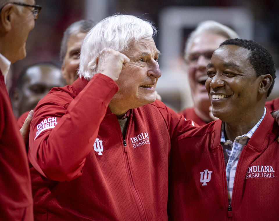 Former Indiana basketball head coach Bobby Knight, left, makes his first appearance at Indiana University since his dismissal in September of 2000. Knight, along with former player Isiah Thomas, right, are on the court during a ceremony with the Indiana players of the 1980 Big Ten championship team the halftime of an NCAA college basketball game, Saturday, Feb. 8, 2020, in Bloomington, Ind. (AP Photo/Doug McSchooler)