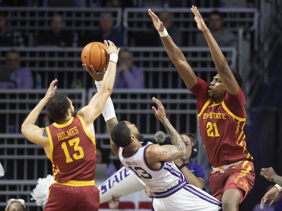 Kansas State's Desi Sills, middle, has his shot blocked by Iowa State's Jaren Holmes, left, while Iowa State's Osum Osunniyi, right, also defends during the first half of an NCAA college basketball game on Saturday, Feb. 18, 2023, in Manhattan, Kan. (AP Photo/Travis Heying)
