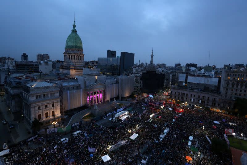 People gather outside the National Congress during a demonstration in support of women and against gender violence, in Buenos Aires