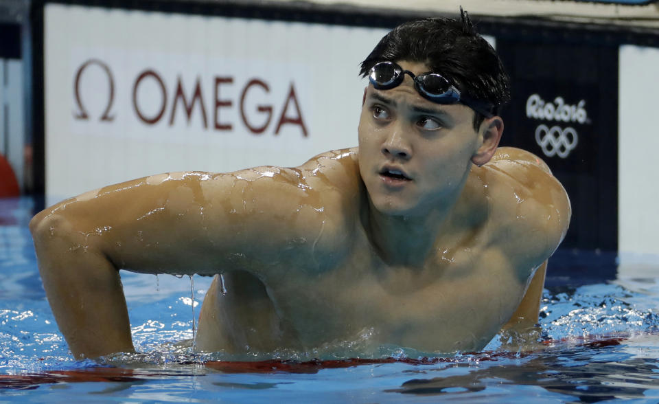 FILE - Singapore's Joseph Schooling looks at the scoreboard after a semifinal of the men's 100-meter butterfly during the swimming competitions at the 2016 Summer Olympics, Thursday, Aug. 11, 2016, in Rio de Janeiro, Brazil. Olympic gold medal swimmer Joseph Schooling has apologized for using cannabis in Vietnam while competing there on leave from military service in his native Singapore. Schooling achieved superstar status in Singapore when he won his country’s first and only Olympic title at the 2016 Rio de Janeiro Games. He won the 100 meters butterfly beating Michael Phelps in the American great’s last Olympic race. (AP Photo/Matt Slocum, File)