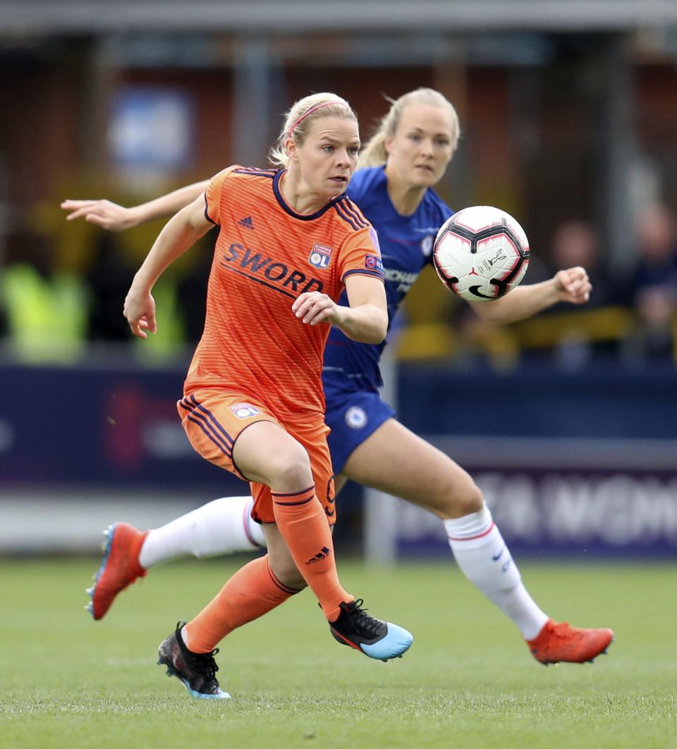 Lyon's Eugenie Le Sommer, front, in action with Chelsea's Magdalene Ericsson during the UEFA Women's Champions League semi final second leg soccer match at the Cherry Red Records Stadium, London, Sunday, April 28, 2019. (Bradley Collyer/PA via AP)