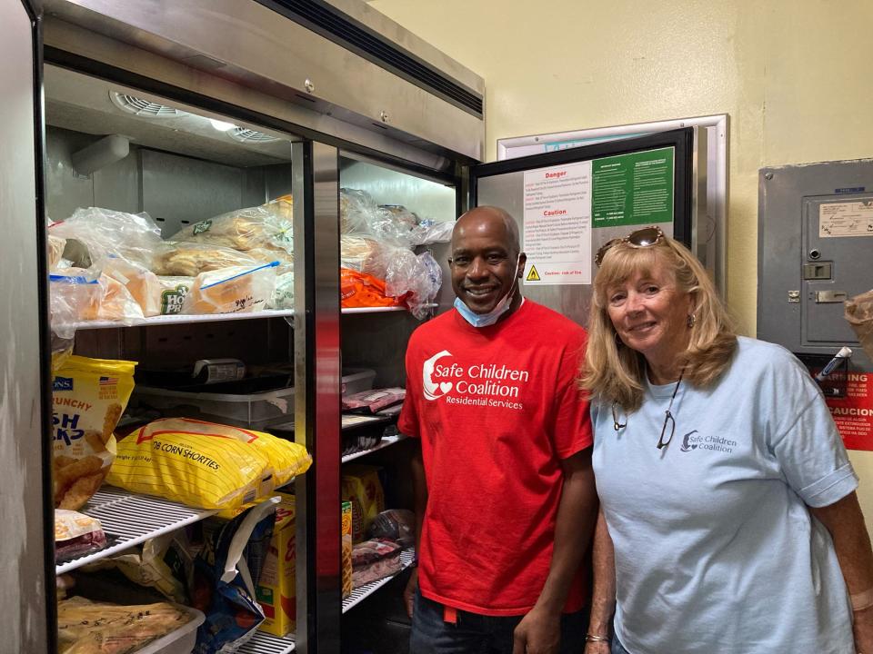 Alan Abernathy and Karen Rapp, of Safe Children Coalition Youth Shelter, with the new freezer purchased in part with a grant from All Faiths Food Bank.