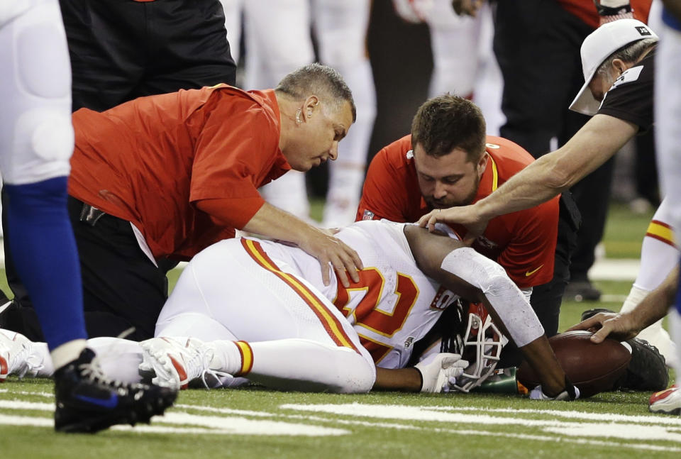 Kansas City Chiefs running back Jamaal Charles (25) is looked at by trainers after going down against the Indianapolis Colts during the first half of an NFL wild-card playoff football game Saturday, Jan. 4, 2014, in Indianapolis. (AP Photo/Darron Cummings)