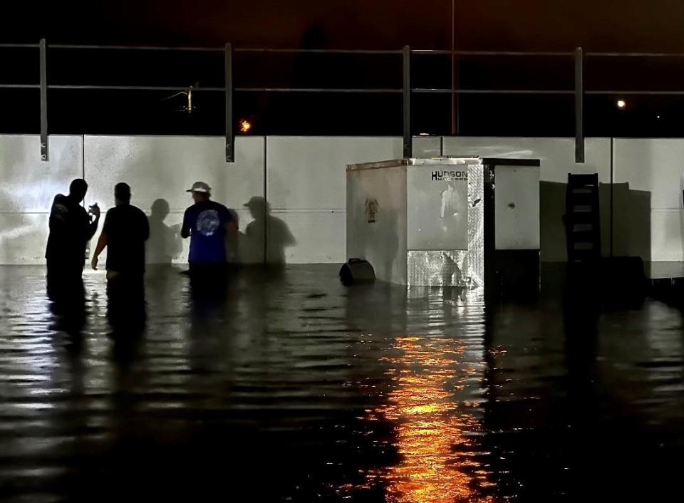 Waist-deep floodwaters swamped Advanced Roof Technology on Saturday night. Owner Steven Scott said he measured water 29 inches deep against the white Brightline railroad embankment wall along the east side of the property.