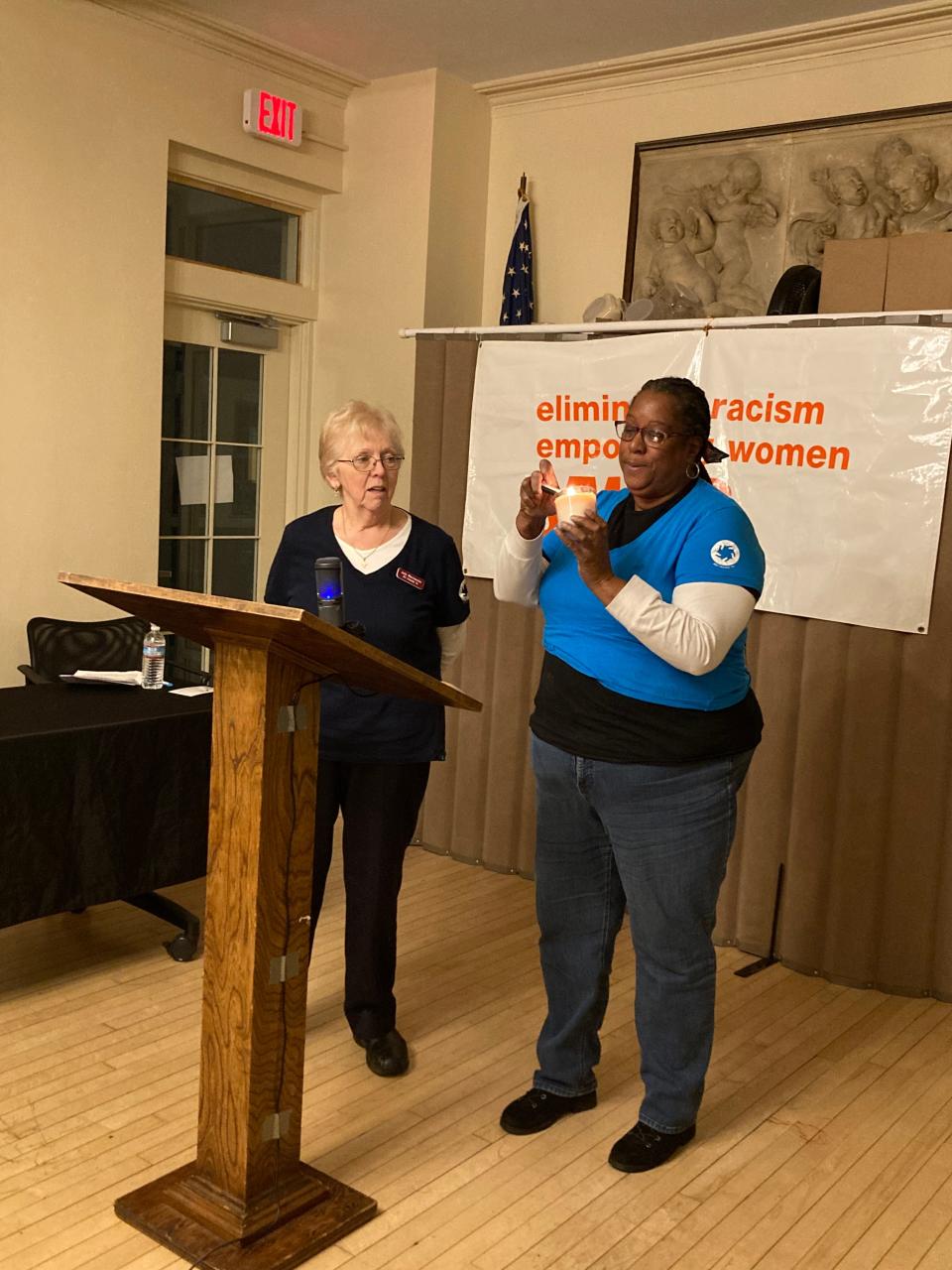 Maria Morris of the YWCA in New Bedford lights a candle with Judy Mackenzie of All Hands In Jan. 26.
(Photo: Kathryn Gallerani/Standard-Times)