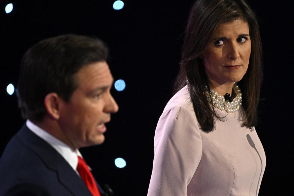 Florida Governor Ron DeSantis (L) speaks as former US Ambassador to the UN Nikki Haley (R) looks at him during the fifth Republican presidential primary debate at Drake University in Des Moines, Iowa, on January 10, 2024. (Photo by Jim WATSON / AFP) (Photo by JIM WATSON/AFP via Getty Images) ORG XMIT: 776073178 ORIG FILE ID: 1915750085