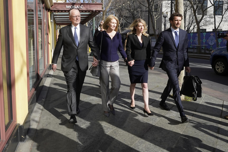 Former Theranos CEO Elizabeth Holmes, center right, walks to federal court with her partner, Billy Evans, right, her father, Christian Holmes IV, left, and her mother, Noel Holmes, in San Jose, Friday, March 17, 2023. (AP Photo/Jeff Chiu)