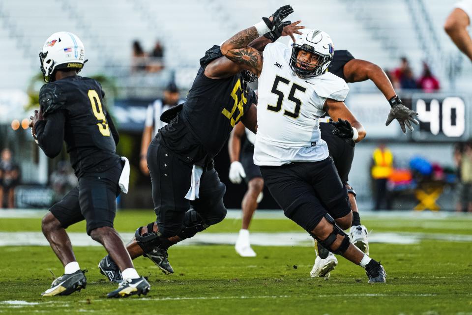 Defensive lineman John Walker (55) pressures quarterback Timmy McClain during UCF's spring football game at FBC Mortgage Stadium, Friday, April 12, 2024.