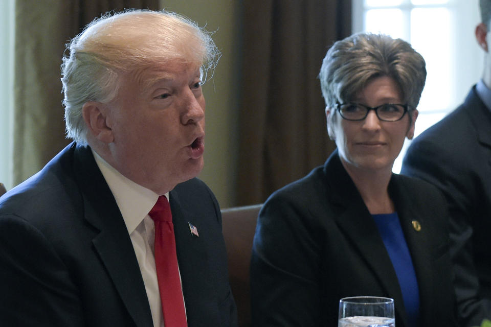 FILE - In this June 13, 2017 file photo, President Donald Trump speaks before having lunch with Republican senators in the Cabinet Room of the White House in Washington, as Sen. Joni Ernst, R-Iowa, listens. Ernst says she turned down Donald Trump's request to run as his vice president in 2016 because of family concerns. Ernst made the claim in an affidavit in a divorce proceeding in October that was first reported by CityView, a Des Moines weekly newspaper. The filing was unsealed earlier this month after Ernst and her former husband of 25 years, Gail Ernst, settled their previously contentious divorce. (AP Photo/Susan Walsh, File)