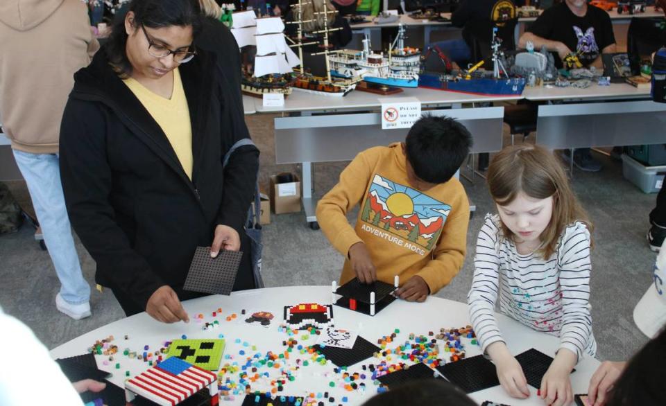 Olathe residents Sahiti Galla, Shawn Gollapalli, 7, and Hannah Schmidt, 6, take the chance to get hands-on with Legos at the KC Brick Lab Showcase Feb. 24. Beth Lipoff/Special to The Star