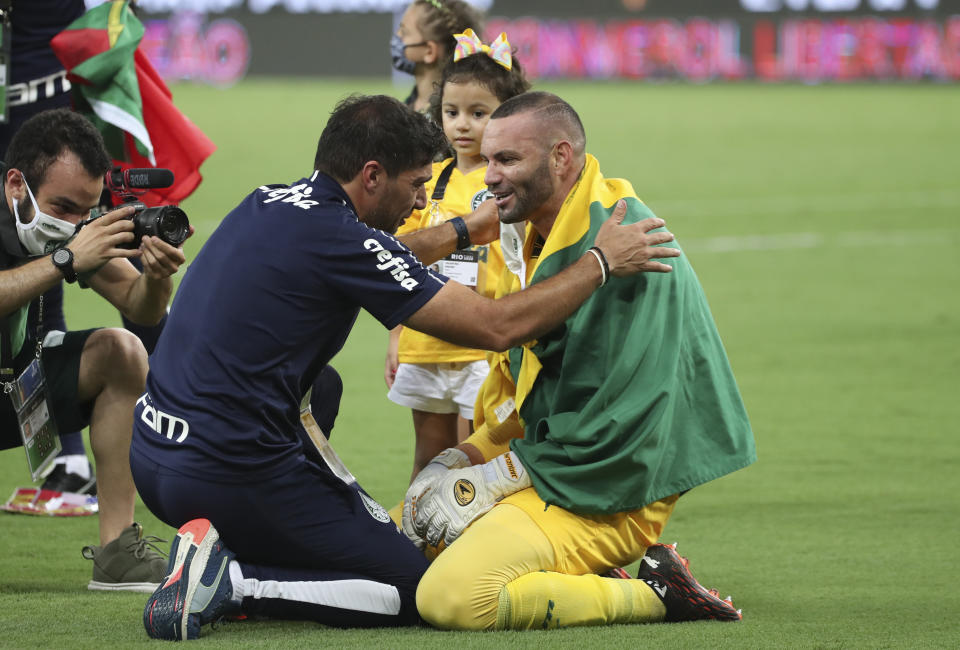 Coach Abel Ferreira of Brazil's Palmeiras greets goalkeeper Weverton after winning the Copa Libertadores final soccer match against Brazil's Santos at the Maracana stadium in Rio de Janeiro, Brazil, Saturday, Jan. 30, 2021. Palmeiras won 1-0. (Ricardo Moraes/Pool via AP)