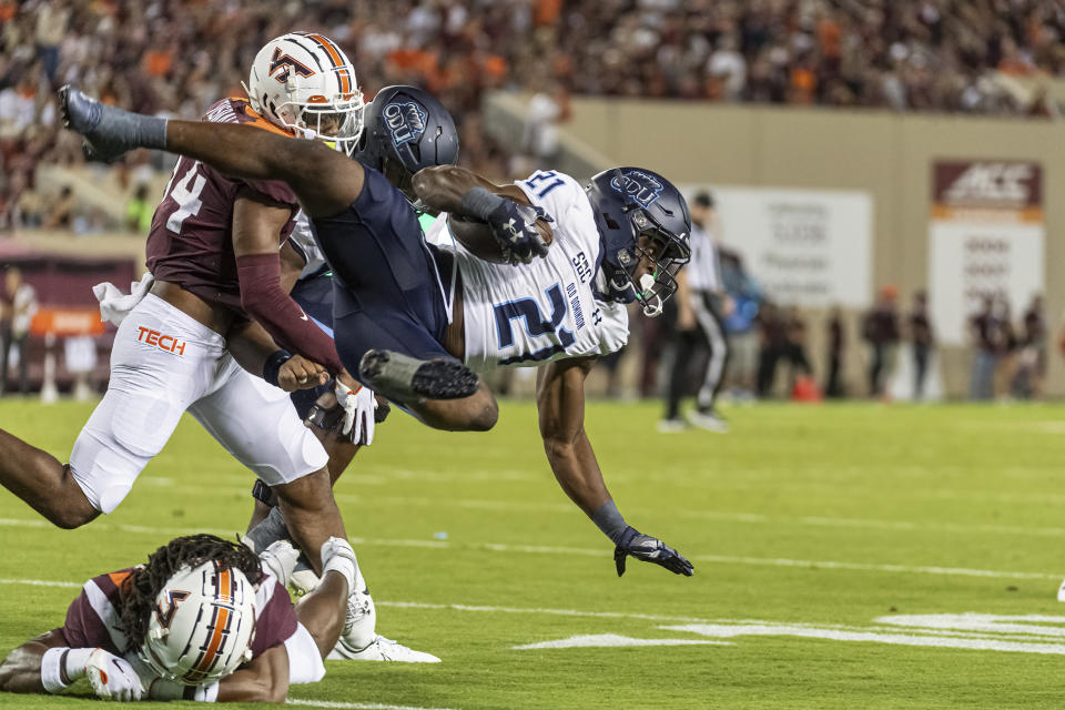 Old Dominion's Obie Sanni is upended by a Virginia Tech defender during the first half of an NCAA college football Saturday, Sept. 2, 2023, in Blacksburg, Va. (AP Photo/Robert Simmons)