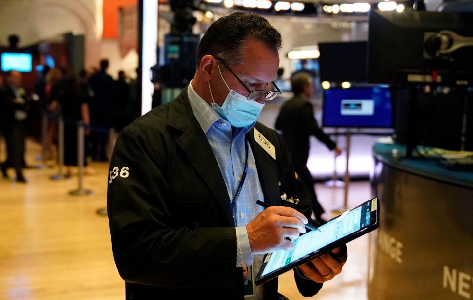 Traders work on the floor at the New York Stock Exchange in New York, on July 29, 2021. - Wall Street stocks climbed early July 29 following another round of mostly strong earnings and US data that showed strong second-quarter growth that lagged expectations. (Photo by TIMOTHY A. CLARY / AFP) (Photo by TIMOTHY A. CLARY/AFP via Getty Images)